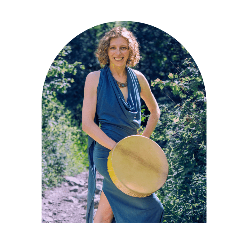 spiritual woman standing with a shamanic drum