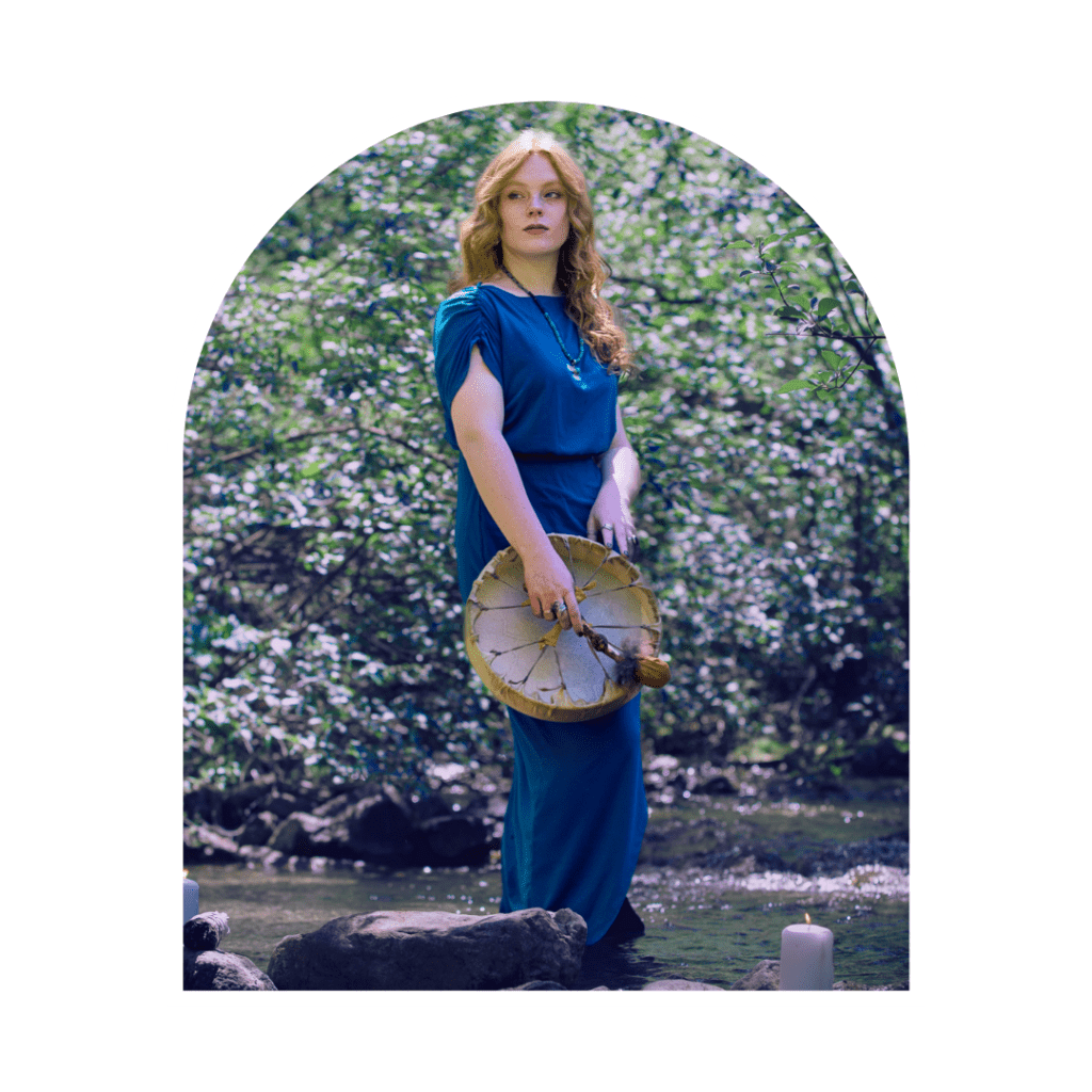 spiritual woman standing in a river with a shamanic drum