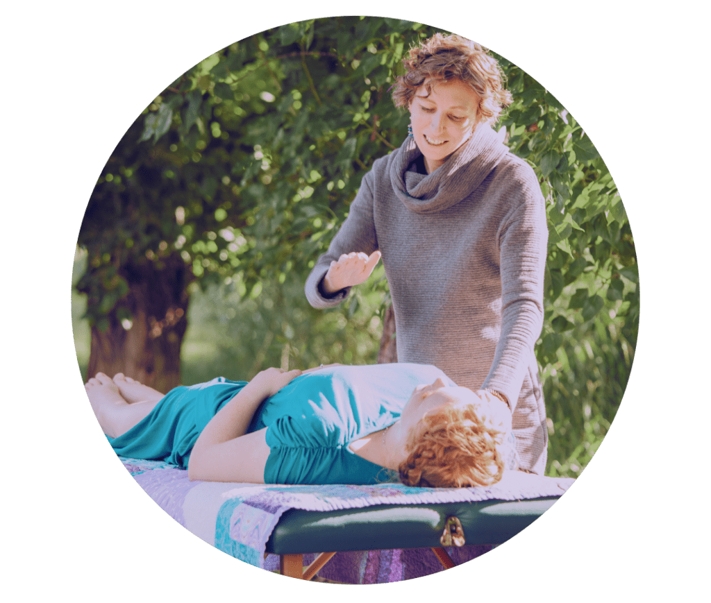 woman doing a shamanic reiki session on another woman in the forest