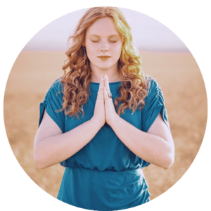 spiritual woman standing with her hands in prayer position