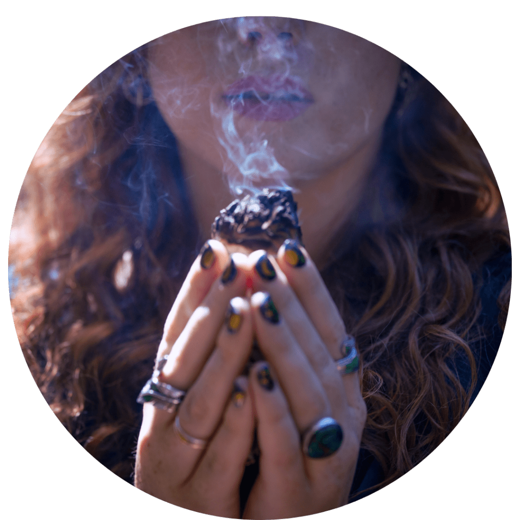 woman holding a shamanic healing sage bundle