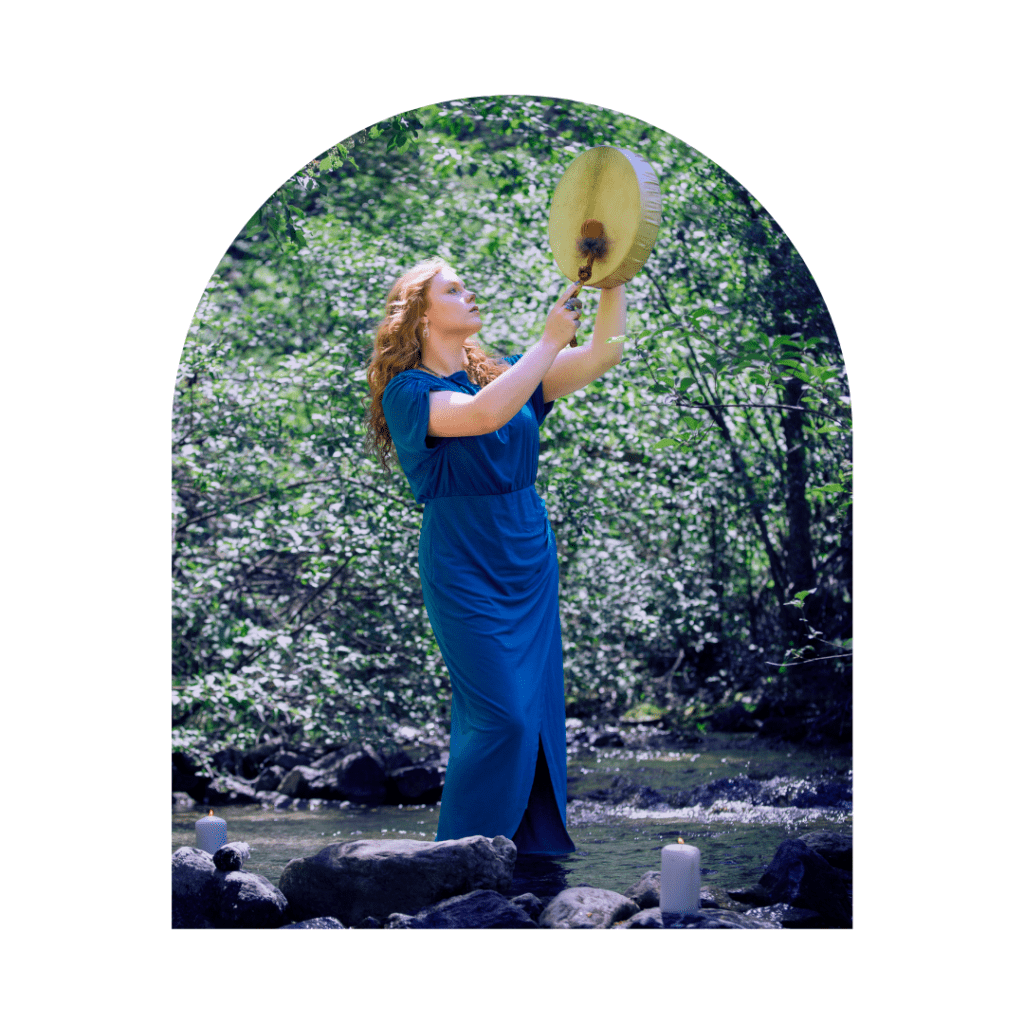 spiritual woman standing in a river playing a shamanic healing drum