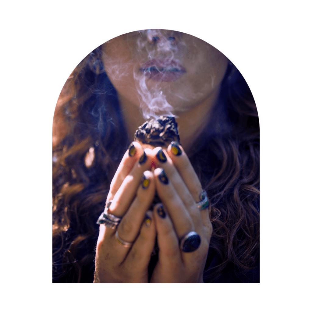 woman holding a smoking sage stick