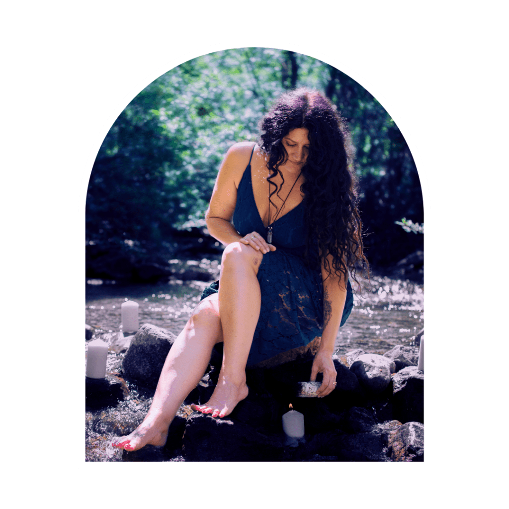 woman lighting a healing sage bundle on a candle