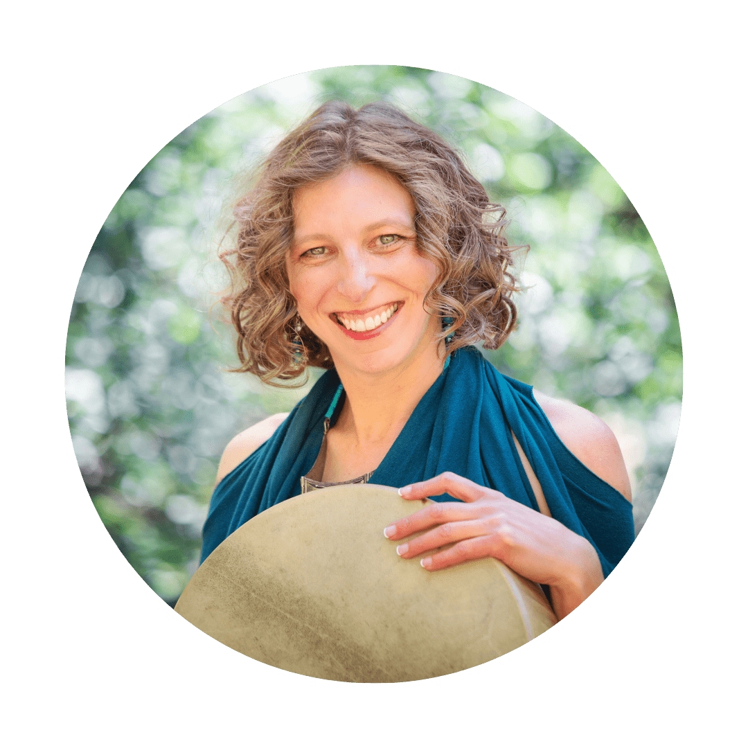 woman smiling with a shamanic drum