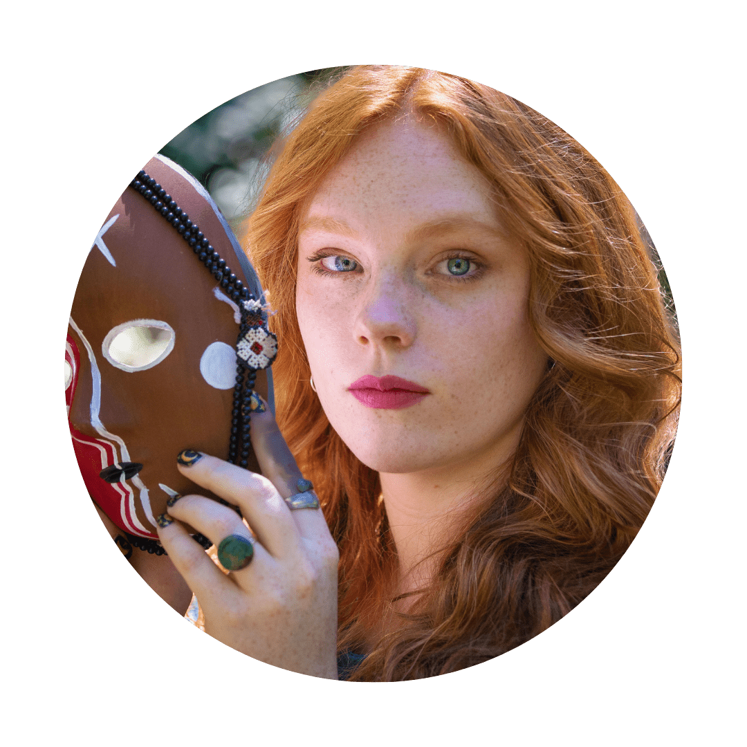 spiritual woman holding a shamanic healing mask