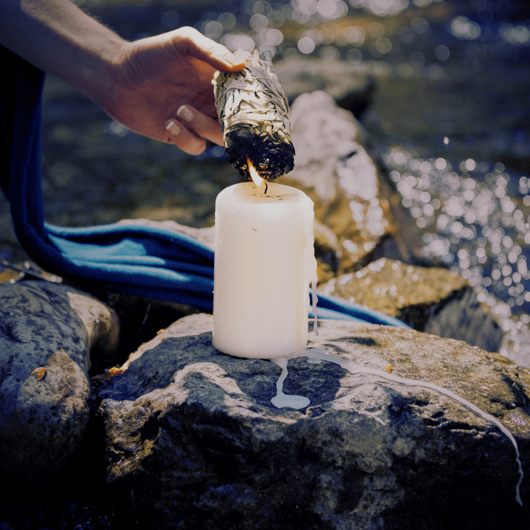 shamanic sage bundle being lit by a candle