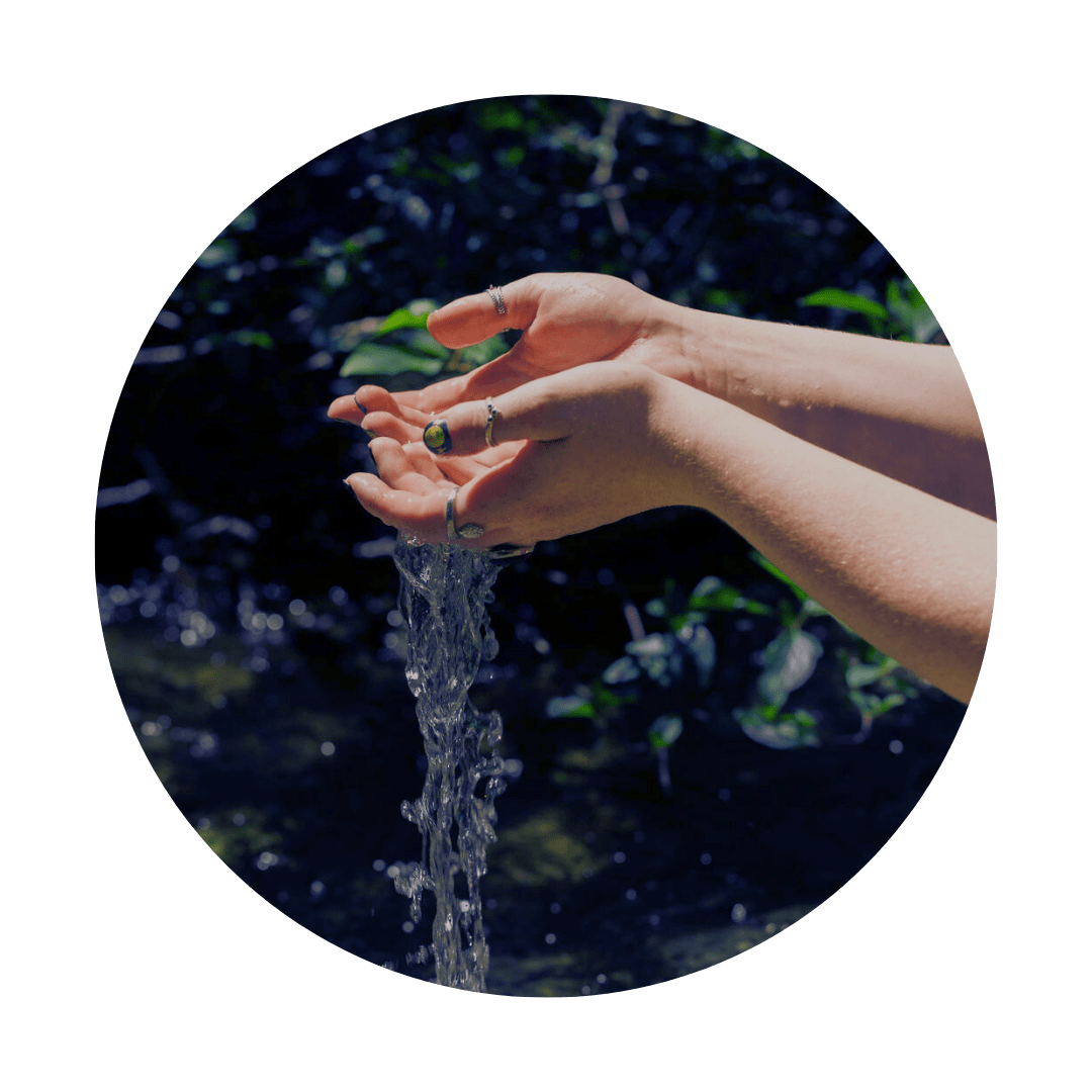 two hands holding running water