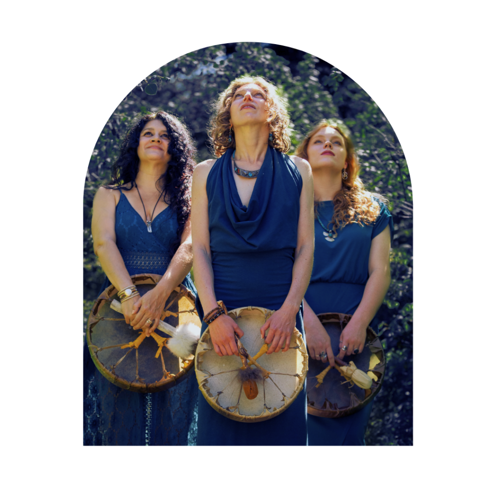 Three shamanic women holding healing drums looking at the sky