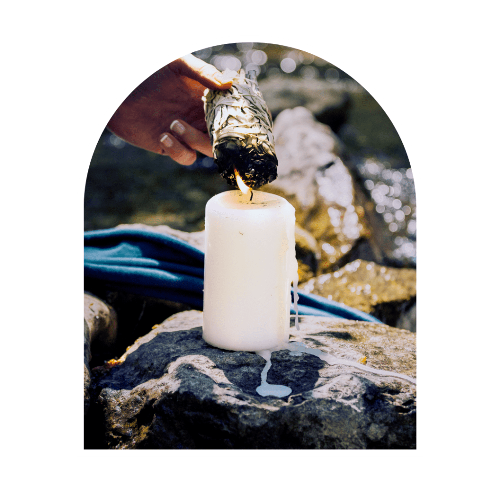 healing sage bundle being lit by a candle