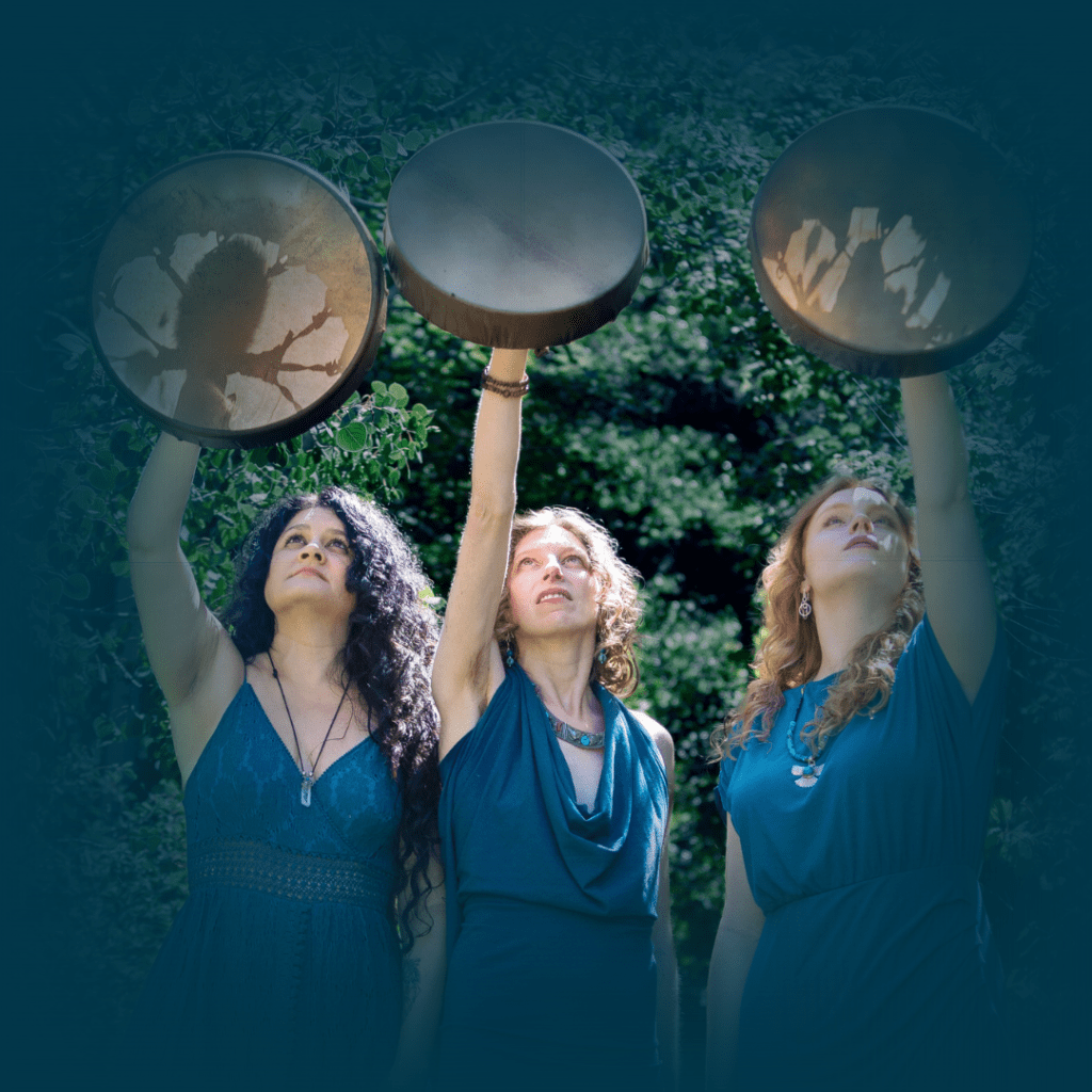 three spiritual women holding shamanic drums up towards the moon