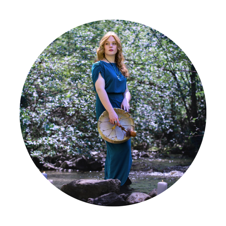 shamanic spiritual woman standing with a healing drum in a river